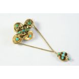A VICTORIAN TURQUOISE AND GOLD BROOCH the gold ornate mount is set overall with turquoise cabochons,