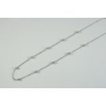 A DIAMOND AND GOLD CHAIN NECKLACE the 18ct white gold chain is mounted with ten roundells each set