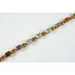 A GOLD AND GEM SET BRACELET the gold chain bracelet is mounted with three rectangular-shaped