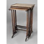 GEORGE IV ROSEWOOD NEST OF THREE TABLES the tops with a shallow gallery, tapering, turned legs and