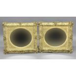 PAIR OF VICTORIAN GILT CUSHION FRAMED MIRRORS the oval plate inside scrolling spandrils and