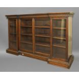ANGLO INDIAN PADAUK WOOD REVERSE BREAKFRONT BOOKCASE later 19th century, with a stiff leaf frieze