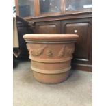 TERRACOTTA PLANTER of slightly tapering, banded circular form with swag decoration, height 62cm,