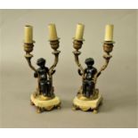 PAIR OF FRENCH BRONZE AND PARCEL GILT TWO LIGHT CANDELABRA 19th century, modelled as a putti