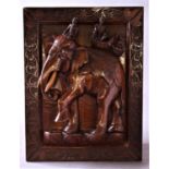 INDIAN HARDWOOD PLAQUE carved in deep relief with an elephant, a mahout and two figures in a howdah,