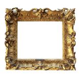 A CARVED GILTWOOD FRAME, 18th CENTURY probably English, with stylised leaf inner frame, oval