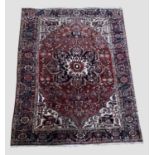 HERIZ AHAR CARPET Iranian Azerbaijan, circa 1930,the chestnut brown field of angular vines around an