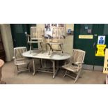 TEAK PATIO DINING SUITE comprising an oval table and six folding, arm chairs (7)