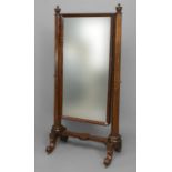 PAIR OF MAHOGANY CHEVAL MIRRORS the rectangular plate on tapering octagonal supports and scrolling