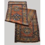 HERIZ RUNNER North West Iran, circa 1900, the terracotta field with a column of hexagons enclosed by