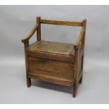 PINE AND ELM BOX SETTLE 19th century, the sloping arms above the seat with a plain panelled base,