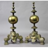 PAIR OF DUTCH STYLE BRASS FIRE DOGS the orb body between a disc knopped finial and stem and mask