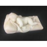 AFTER DUQUESNOY Child asleep on a pillow, white marble, late 19th or 20th century, length 14.5cm,