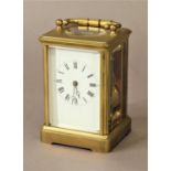 FRENCH BRASS CARRIAGE CLOCK the enamelled dial on a brass, eight day movement, half hourly