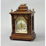WALNUT AND BRASS MOUNTED MANTEL CLOCK late 19th century, the brass dial with a 4 1/2" silvered
