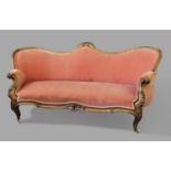 FRENCH WALNUT SOFA the serpentine back with a floral crest above scrolling arms, serpentine seat and