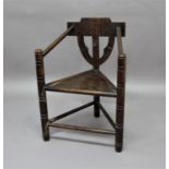 OAK AND ASH WARWICK CHAIR 19th century, with carved back rest and arms, panel seat and turned legs