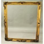 A 19th CENTURY GILT PICTURE FRAME with floral leafy scroll and shell motifs to the corners and