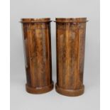 PAIR OF REGENCY STYLE MAHOGANY, OVAL PEDESTALS the single door enclosing shelving, applied with