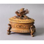 BLACK FOREST JEWELLERY CASKET of oval form, the cover carved with a bird, the sides with foliage,