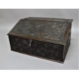 LARGE OAK DESK BOX 18th century, carved with scrolling serpent birds to the cover, butterfly hinges,