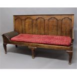 GEORGE III OAK SHEPHERDS OR LAMBING SETTLE the five panelled back above a padded and scrolling arm