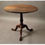 GEORGE III CIRCULAR MAHOGANY TILT TOP TRIPOD TABLE with a tapering and wrythen column and tripod