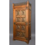 CONTINENTAL GOTHIC OAK WARDROBE later 19th century, the pierced gallery above a single door carved