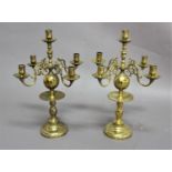 PAIR OF DUTCH STYLE BRASS FIVE LIGHT CANDELABRA with four scrolling arms on a ball and baluster