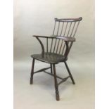 COMB BACK WINDSOR CHAIR mid 19th century, ash and elm, with a horse shoe arm rest with scrolled