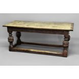 OAK REFECTORY TABLE 17th century and later, the cleated top above foliate carved aprons, cup and