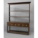 GEORGE III OAK DRESSER the two shelf rack, perhaps later, with dentil cornice on a base with three