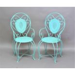 SET OF FOUR WROUGHT IRON GARDEN CHAIRS the arched back with teardrop shaped back rest, scroll