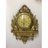 FRENCH GILT WOOD CARTEL STYLE CLOCK the 7" dial on a brass, eight day movement, flanked by winged