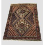 AFSHAR RUG South East Iran, circa 1930, the field with two serrated diamond medallions surrounded by