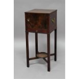 GEORGE III MAHOGANY POT CUPBOARD late 18th century, with a single door, brass carry handles,