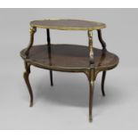 FRENCH TWO TIER ETAGERE each tier of shaped oval form, with gilt brass rams head mounts and brass