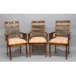 SET OF FOUR INDIAN ROSEWOOD ELBOW CHAIRS in the Colonial style, the bar and spindle backs above
