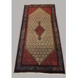 HAMADAN RUG, IRANIAN KURDISTAN the camel lattice field centred by a serrated medallion framed by