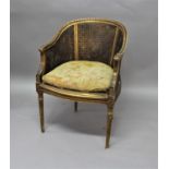 FRENCH LOUIS XVI STYLE GILT BERGERE the double caned back and sides above a serpentine seat and