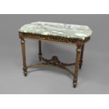 LOUIS XVI STYLE CENTRE TABLE the marble top with bow ends on a base with a carved, foliate apron,