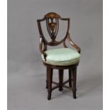 EDWARDIAN INLAID PIANO CHAIR the shield shaped back above a revolving circular foot and turned legs,