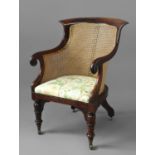MAHOGANY BERGERE mid 19th century, with scrolled arms, drop in seat and tapering, turned front legs,