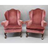 PAIR OF GEORGIAN STYLE WING BACK ARM CHAIRS the camel back above scrolled arms, bow fronted seat,