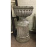 COMPOSITION STONE JARDINIERE AND STAND of lobed form on a circular foot in turn on a fluted column