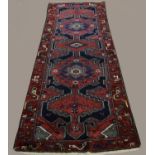 HAMADAN RUNNER Iranian Kurdistan, circa 1950, the midnight blue field with a single column of