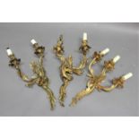 PAIR OF TWIN BRANCH GILT METAL WALL LIGHTS of rococo, foliate form, height excluding fittings