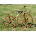 A Rare Child's Vélocipède dating circa 1870, having a 24-inch wooden spoked driving wheel and a 20-