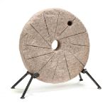 A Small Antique Millstone on Stand