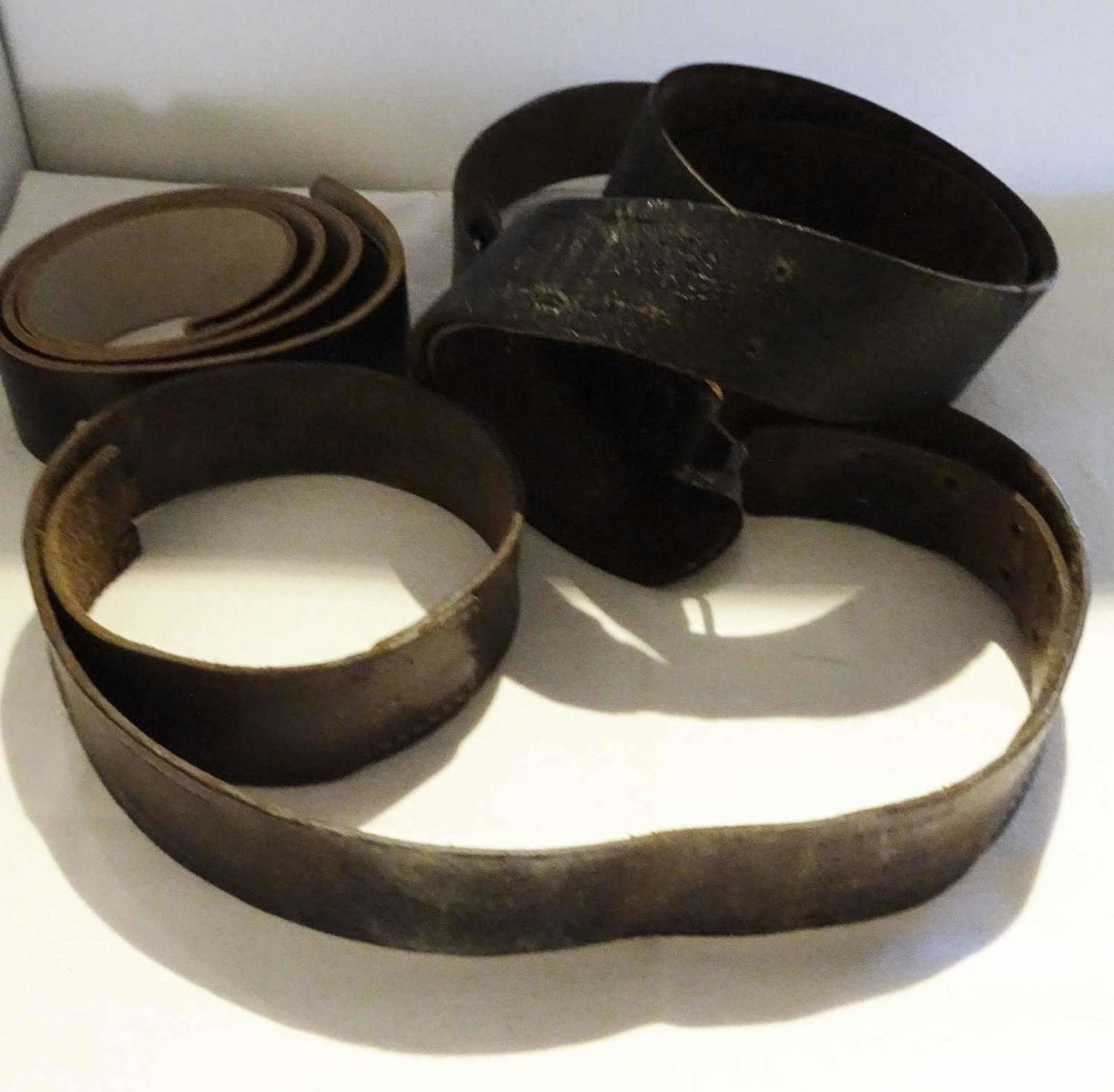 3 ancient leather belt straps, different lengths, probably for the military.